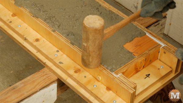 Tap with hammer to settle concrete and remove bubbles