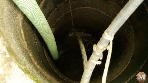 Vacuum Hole sucking out Mud and Sediment from Shallow Well Bottom