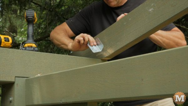 End rafters are secured with a small galvanized angle bracket