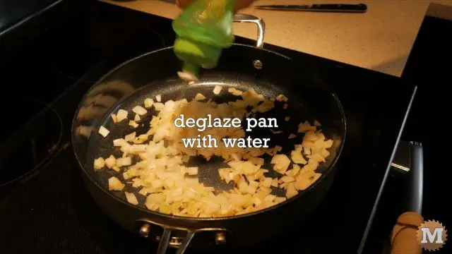 Frying onions. Deglazing the frying pan with water.