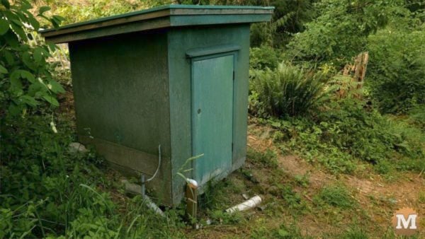 man about tools remove silt mud sediment from well pumphouse Irrigation Well Pumphouse