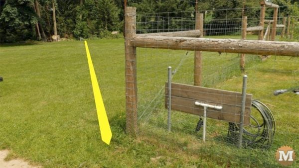 man about tools remove silt mud sediment from well line across field 1" black poly water line runs under field to house