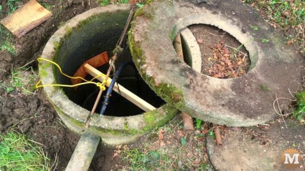 man about tools remove silt mud sediment from well Brace on inside
