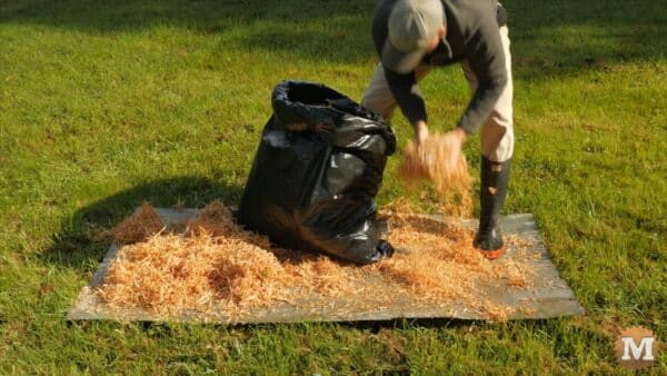 Drying cedar shavings in the sun on some scrap metal Drying cedar shavings in the sun on some scrap metal