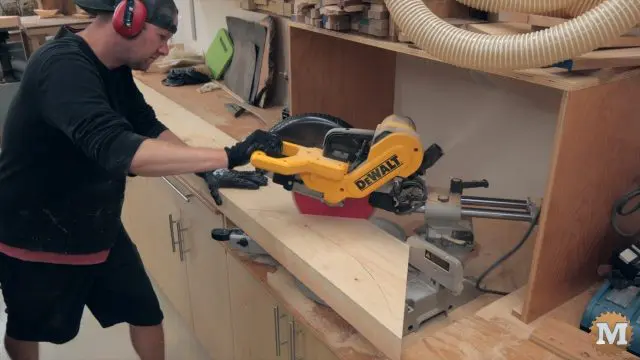 miter saw cutting the corner braces for the Timber Frame style Pavilion from fir
