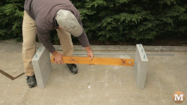sliding the stretcher onto the cast concrete bolts