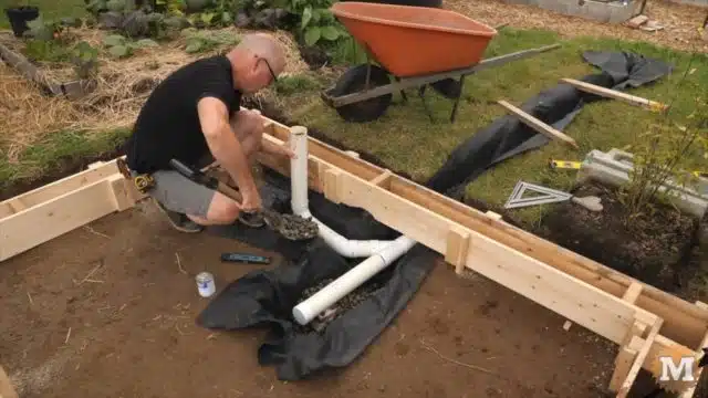 OFF GRID Rainwater Harvesting System - setting drain pipes in place under the tank gravel