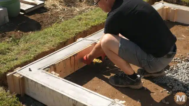 OFF GRID Rainwater Harvesting System - stripping the concrete form from the poured base curb walls