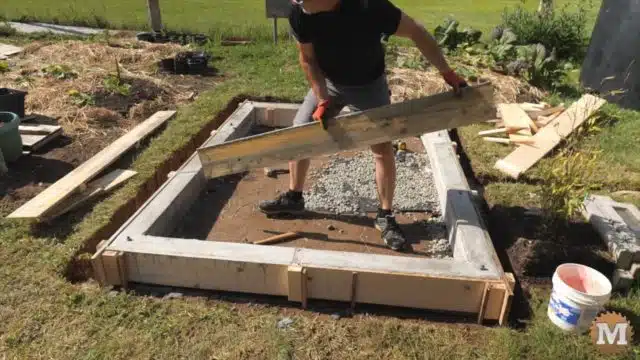 stripping the concrete form from the poured base curb walls