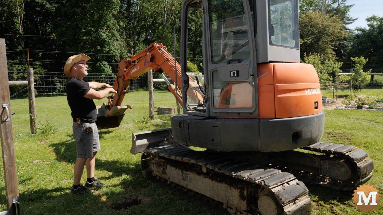 Excavator ready to dig foundation hole