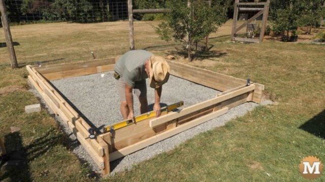 Checking the concrete form walls with a spirit level