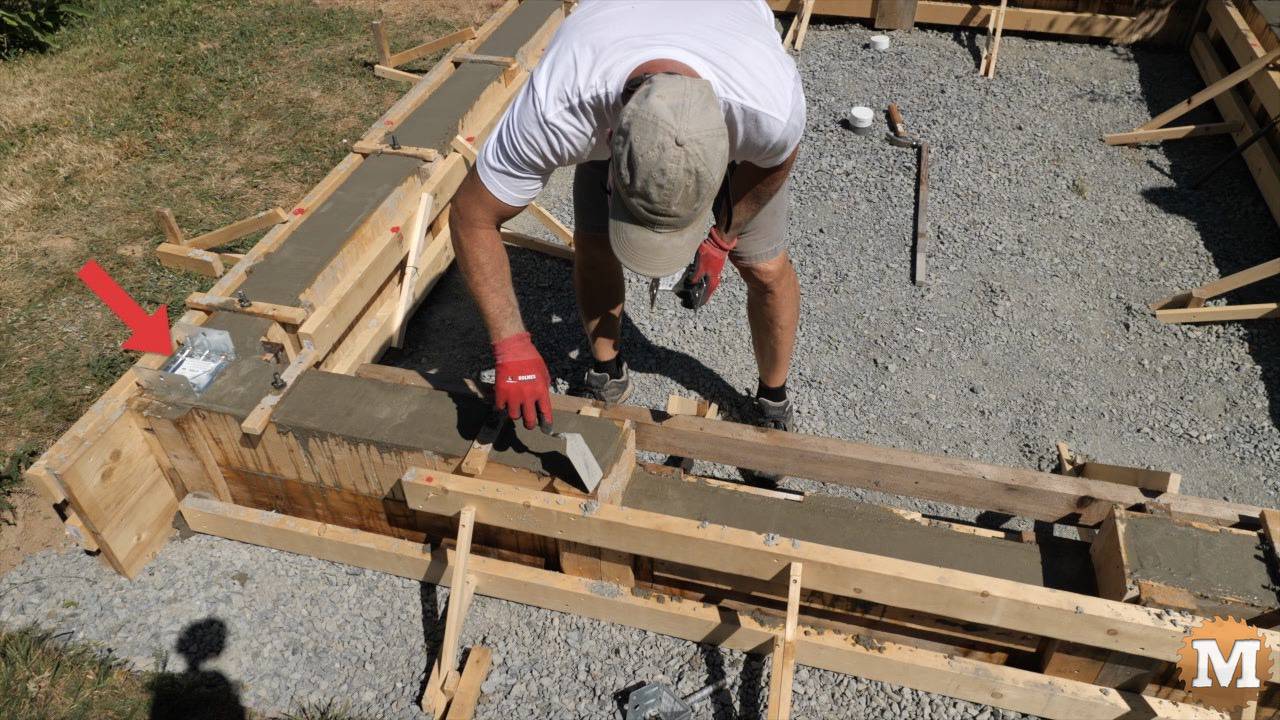 setting a 4x4 galvanized post saddle into wet concrete
