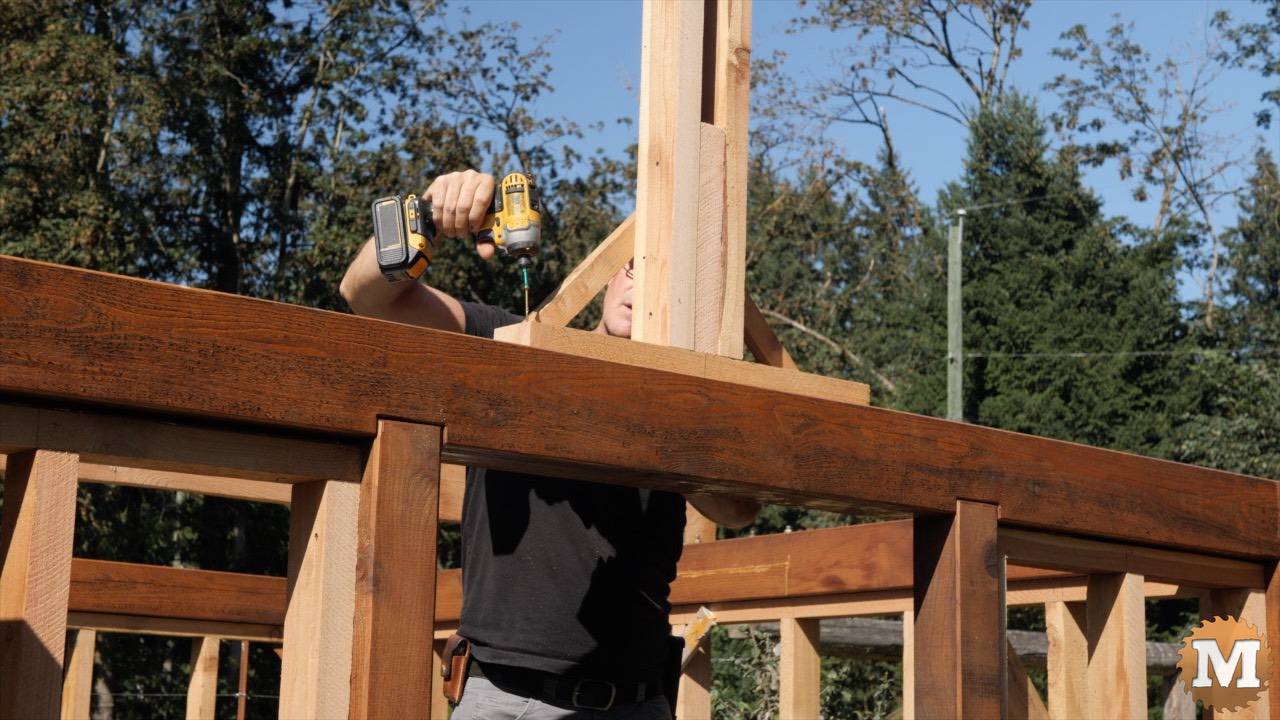 Ridge beam temporary support brackets screwed to cross tie