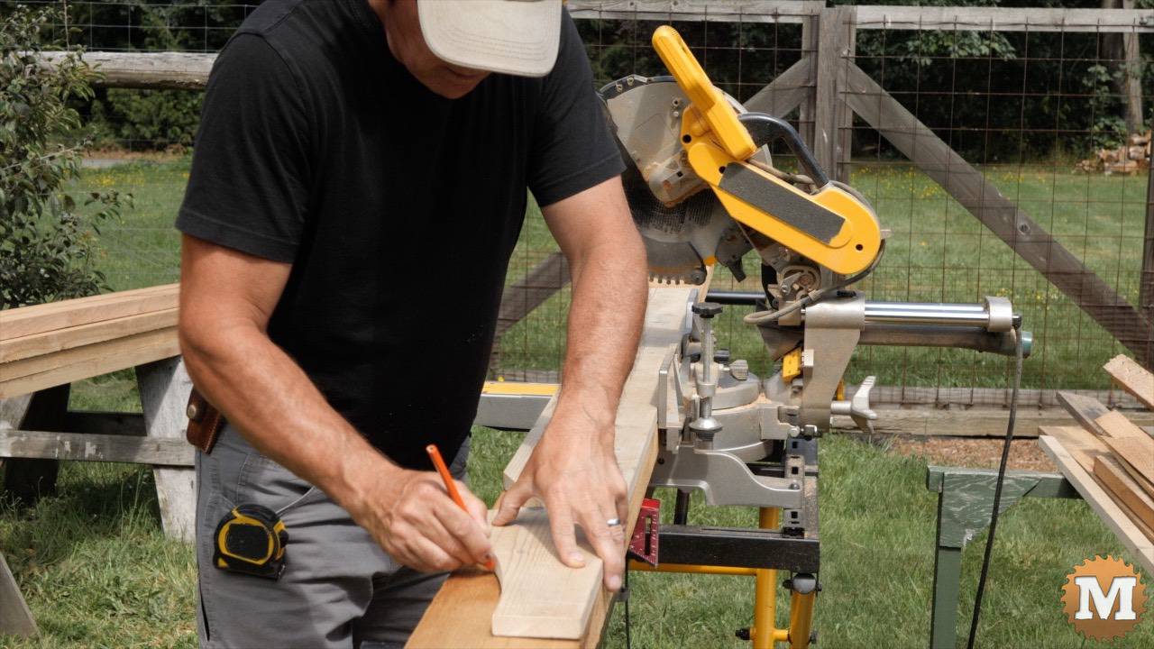 Tracing a tail pattern on a cedar greenhouse rafter
