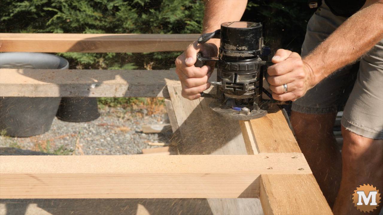 Router cutting glazing relief in cedar greenhouse door