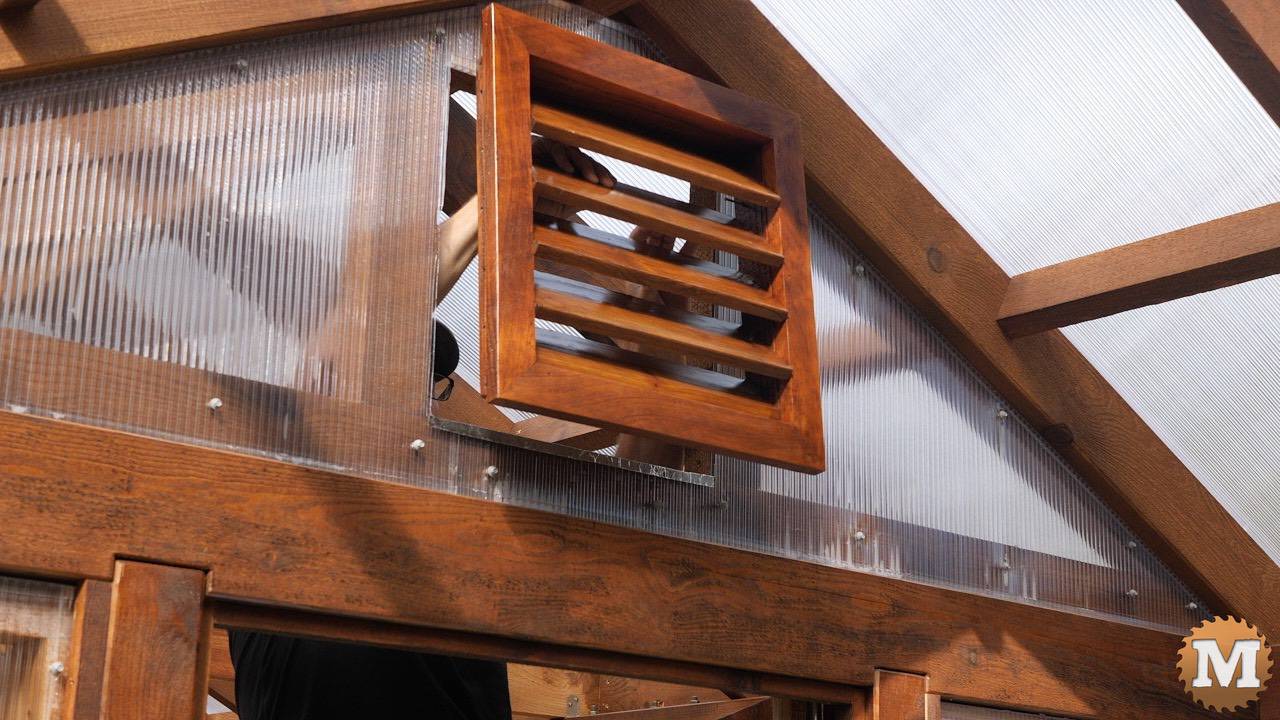 Installing cedar louvered vents in the front gable of a greenhouse