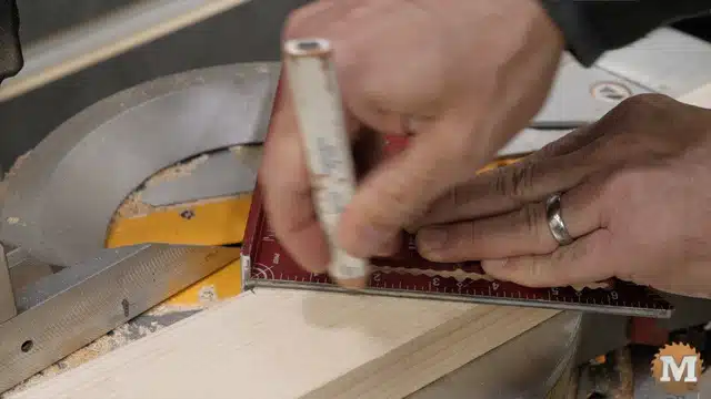 Using a small speed square to mark cuts for the upper shelf braces