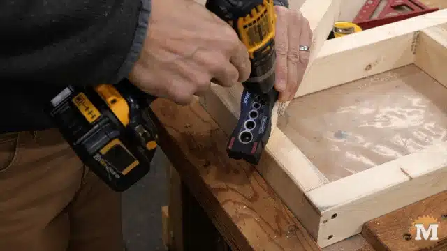 Using a drill block guide for pilot holes in the upper shelf braces
