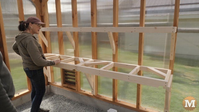 Marilyn is having a look at the new greenhouse shelves