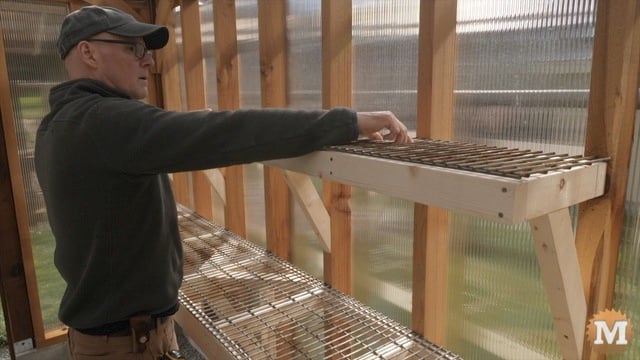 Setting the last wire grid on the upper shelf frame