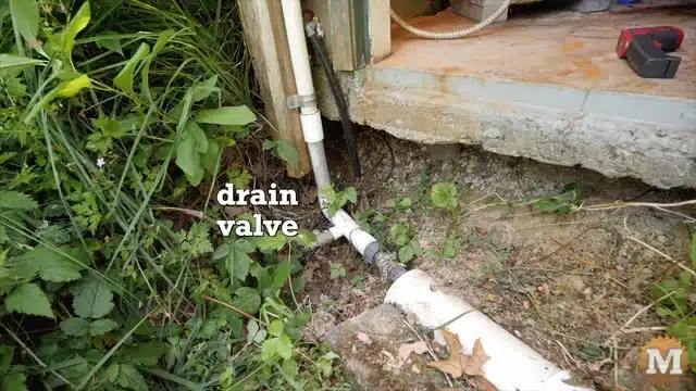 Shallow well pump setup - drain valve outside doorway