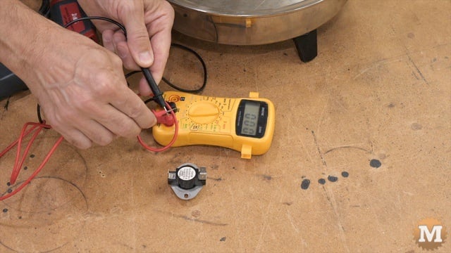Doing a continuity test of the thermostat with a digital test meter