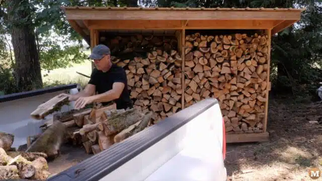 loading the dried firewood into a pickup bed