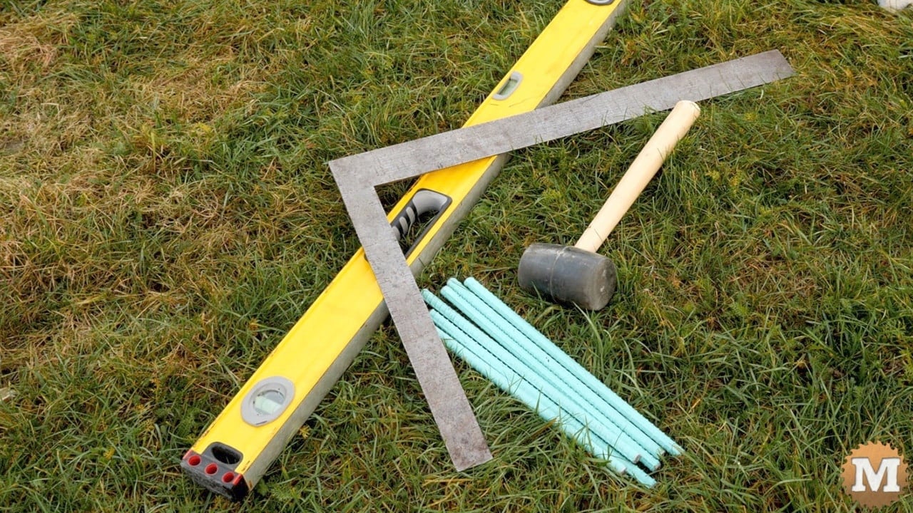 for this demonstration bed I'll assemble it on grass using a spirit level, framing square, rubber mallet, and some foot long rebar sections