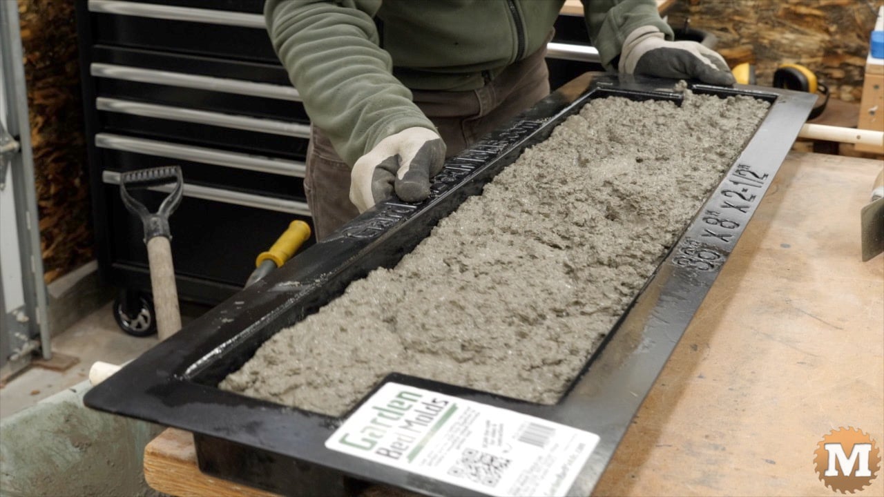 giving the forms a shake side to side to settle the concrete