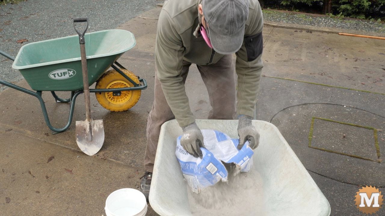 emptying bag of high strength concrete into a wheelbarrow