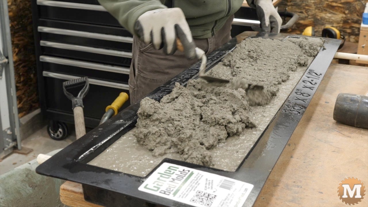 a small trowel is useful for pushing the concrete toward the edges