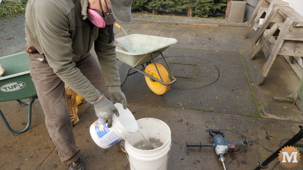 some water is added on top of the dry concrete mix