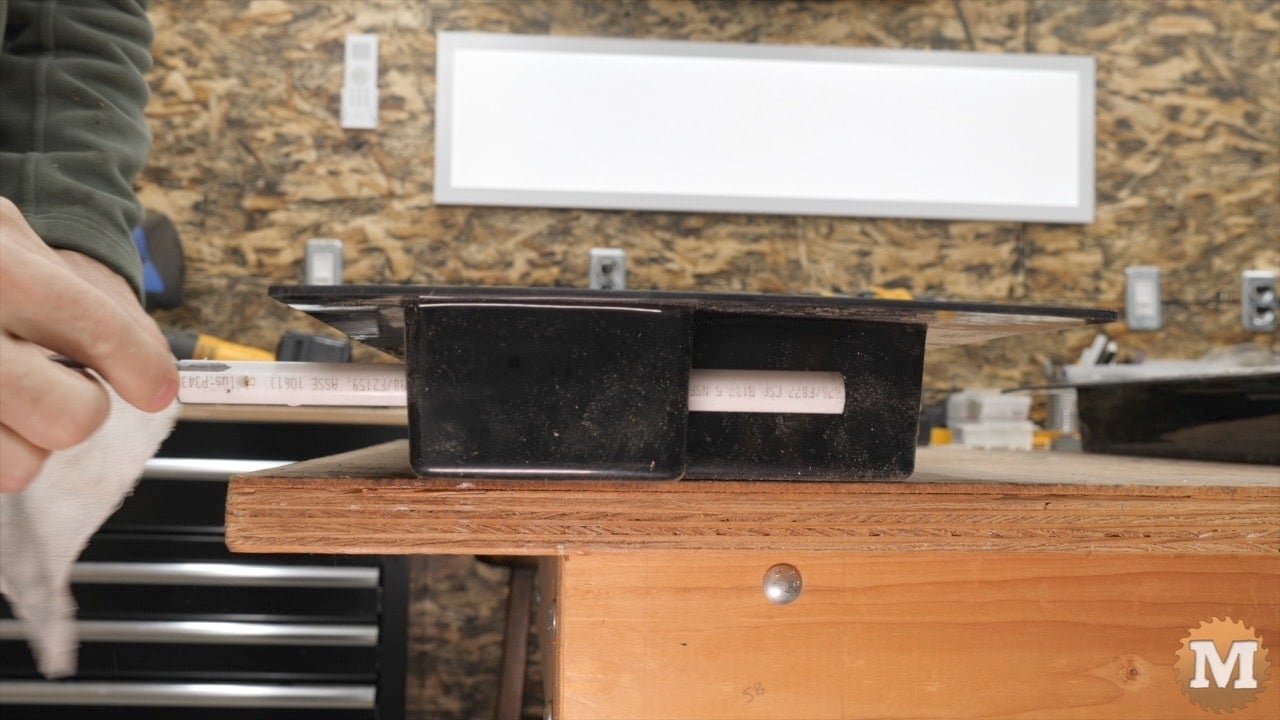 a nail is slid into the hole in the pipe