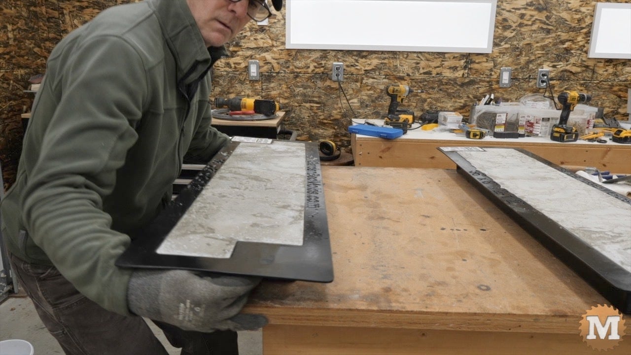 lifting the loaded mold underneath while gripping the lapped corners