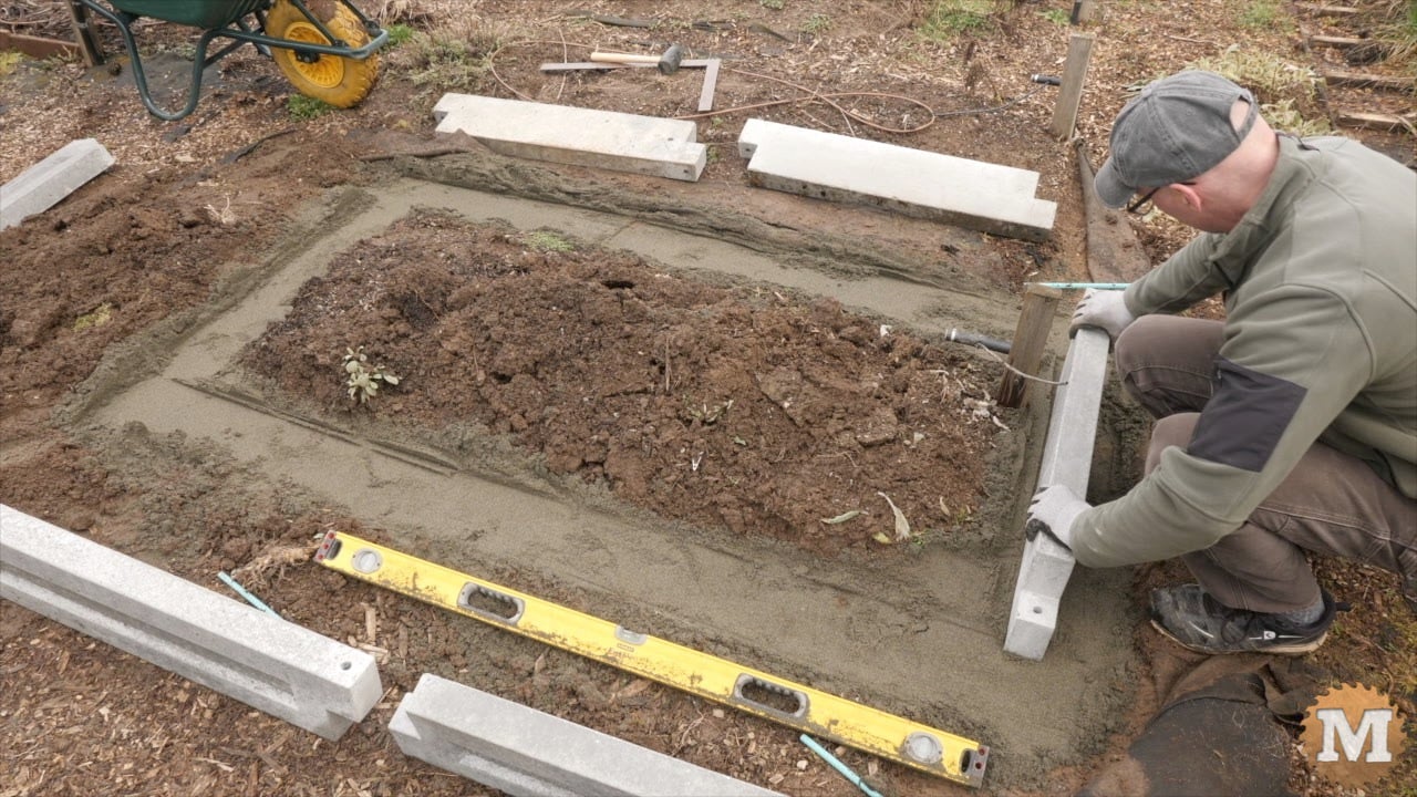 setting the first panel on the sand and levelling it