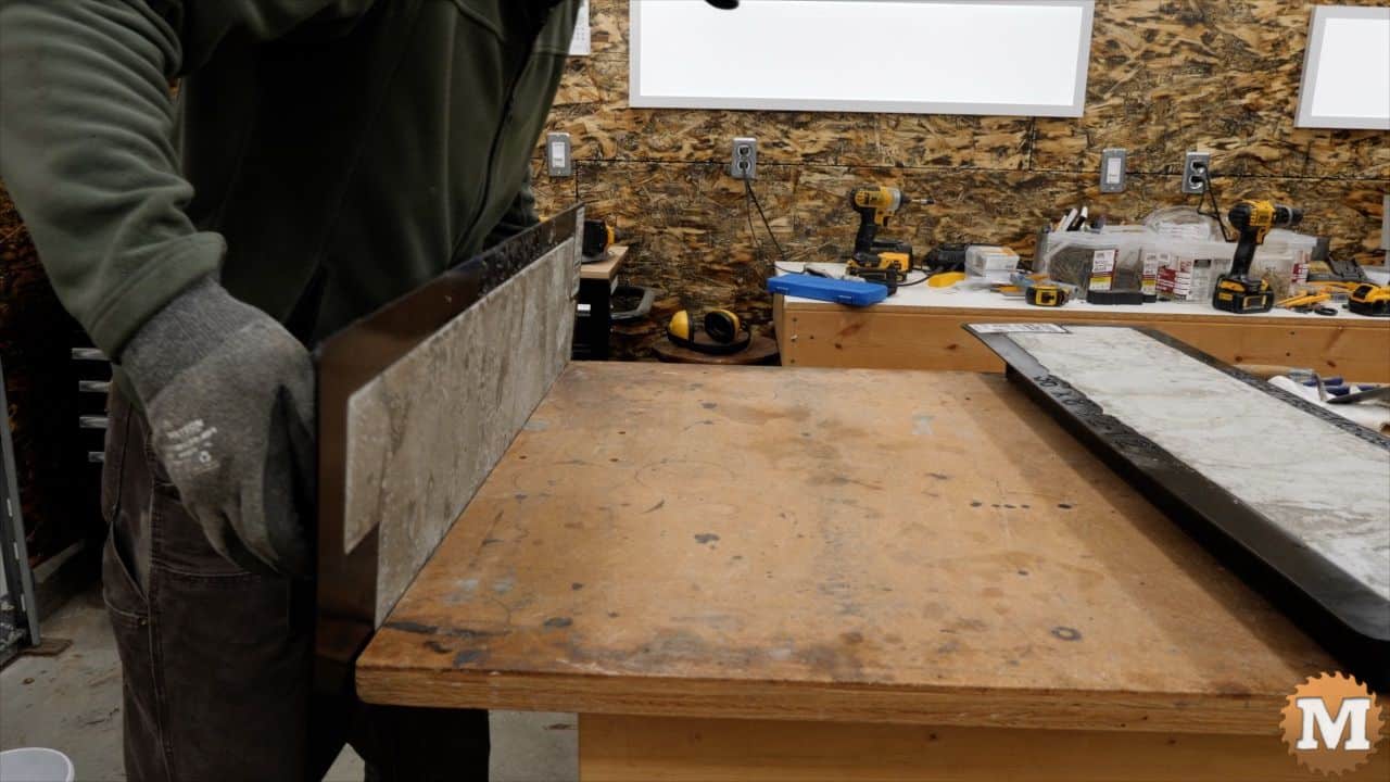 rotating the mold upside down onto a workbench