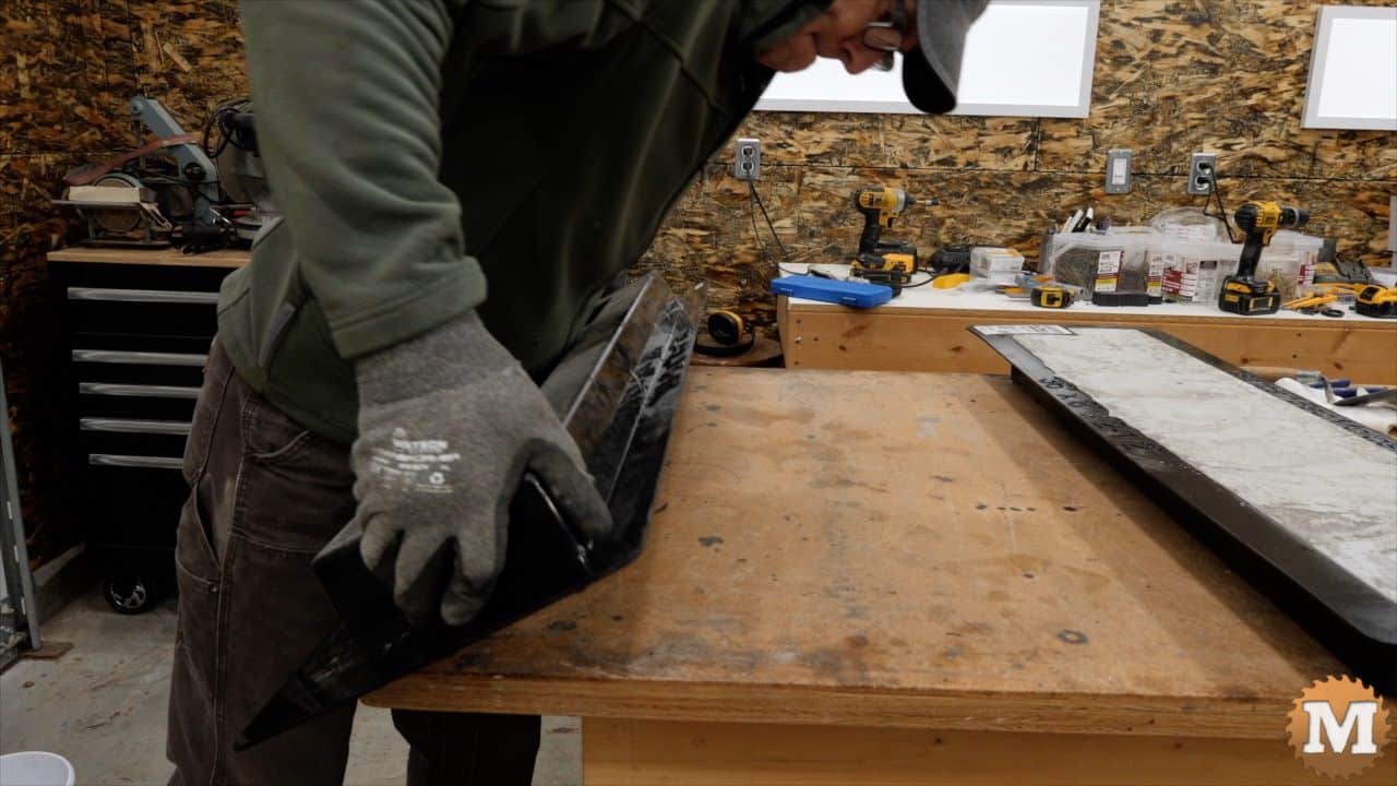 rotating the mold upside down onto a workbench