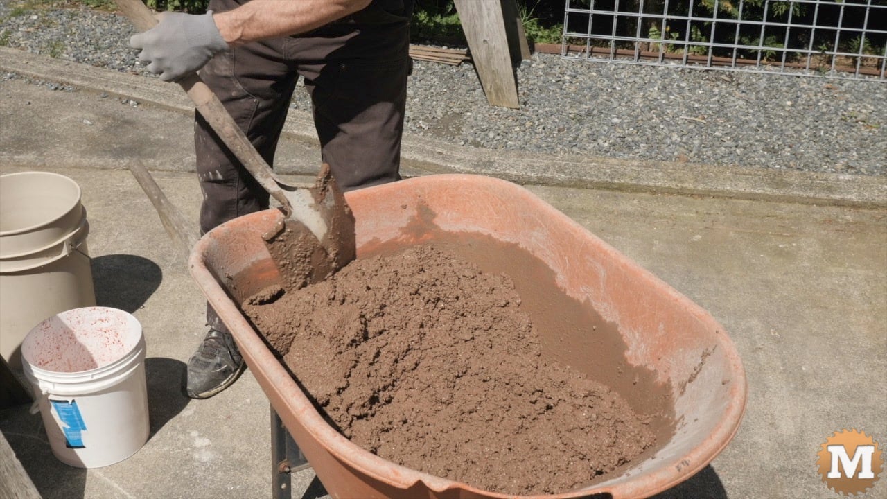 Red concrete mixed in a wheelbarrow