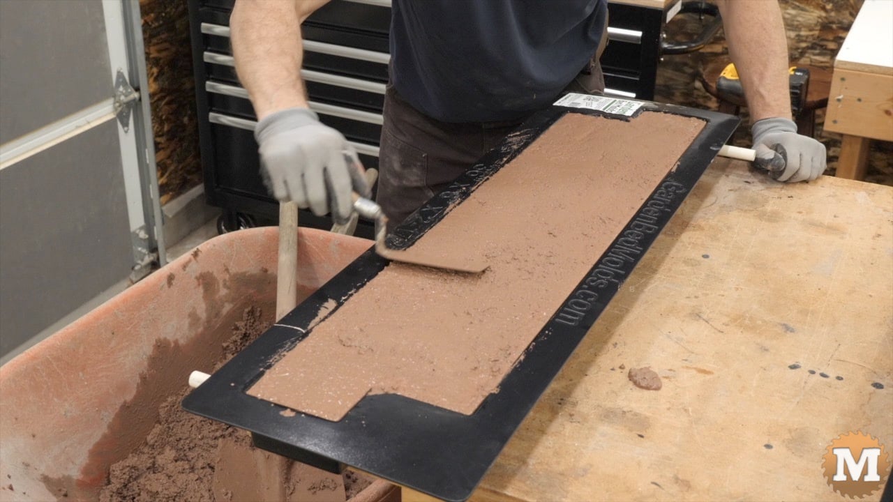 troweling wet concrete in a mold