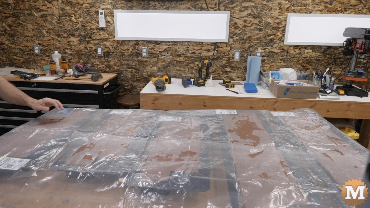 Plastic sheets covering concrete molds in a workshop