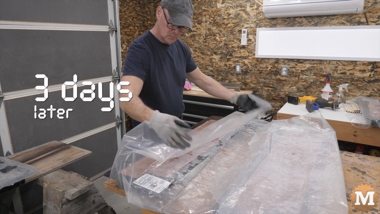 A man uncovering fresh concrete castings