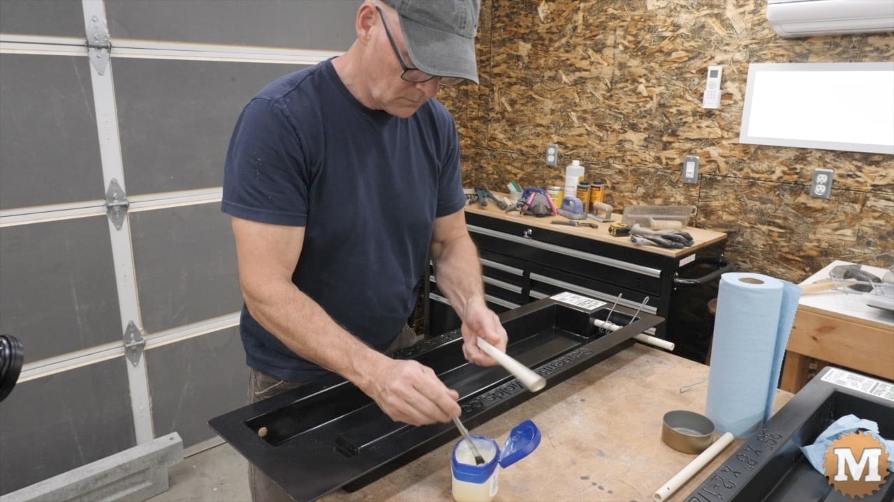 A man preparing a concrete mold
