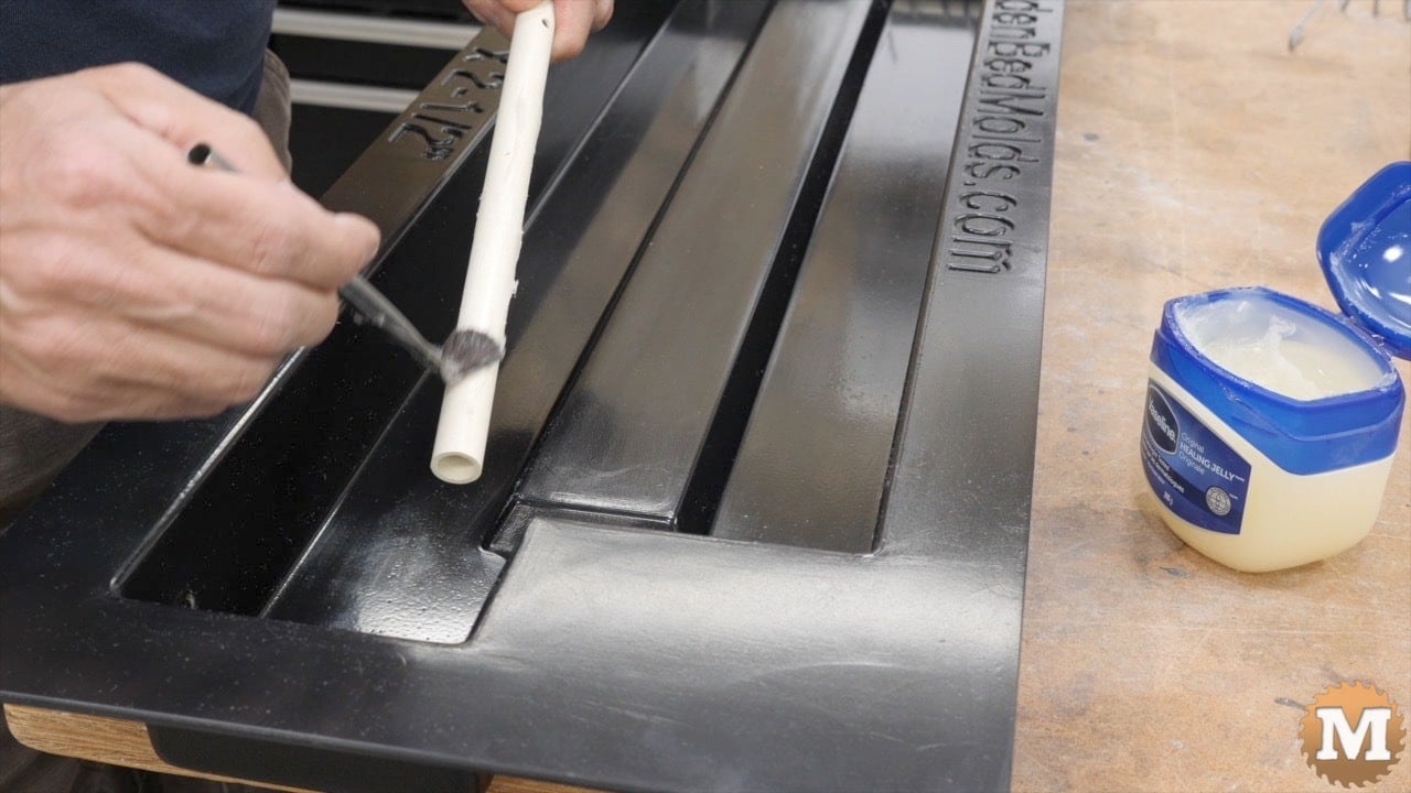 Brushing on Vaseline to a plastic pipe