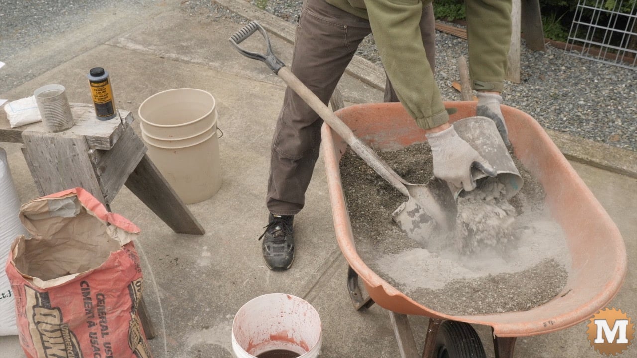 A man poring portland cement into a wheelbarrow