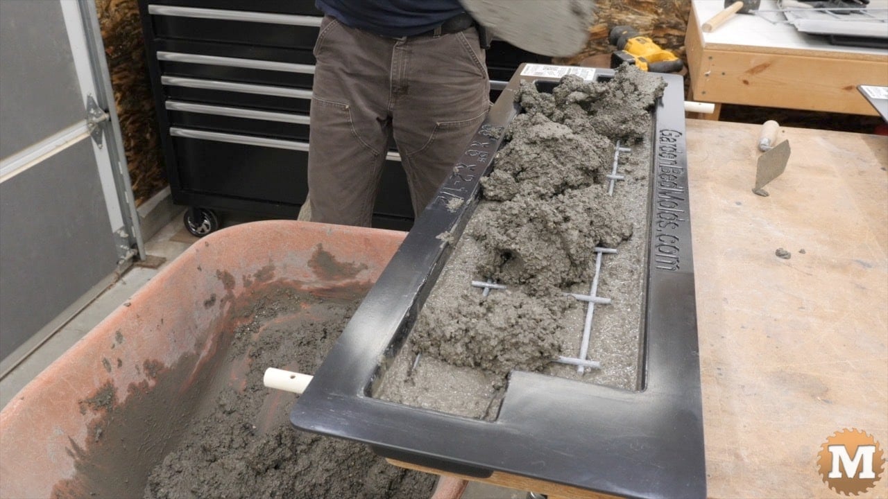 Adding more wet concrete to the mold