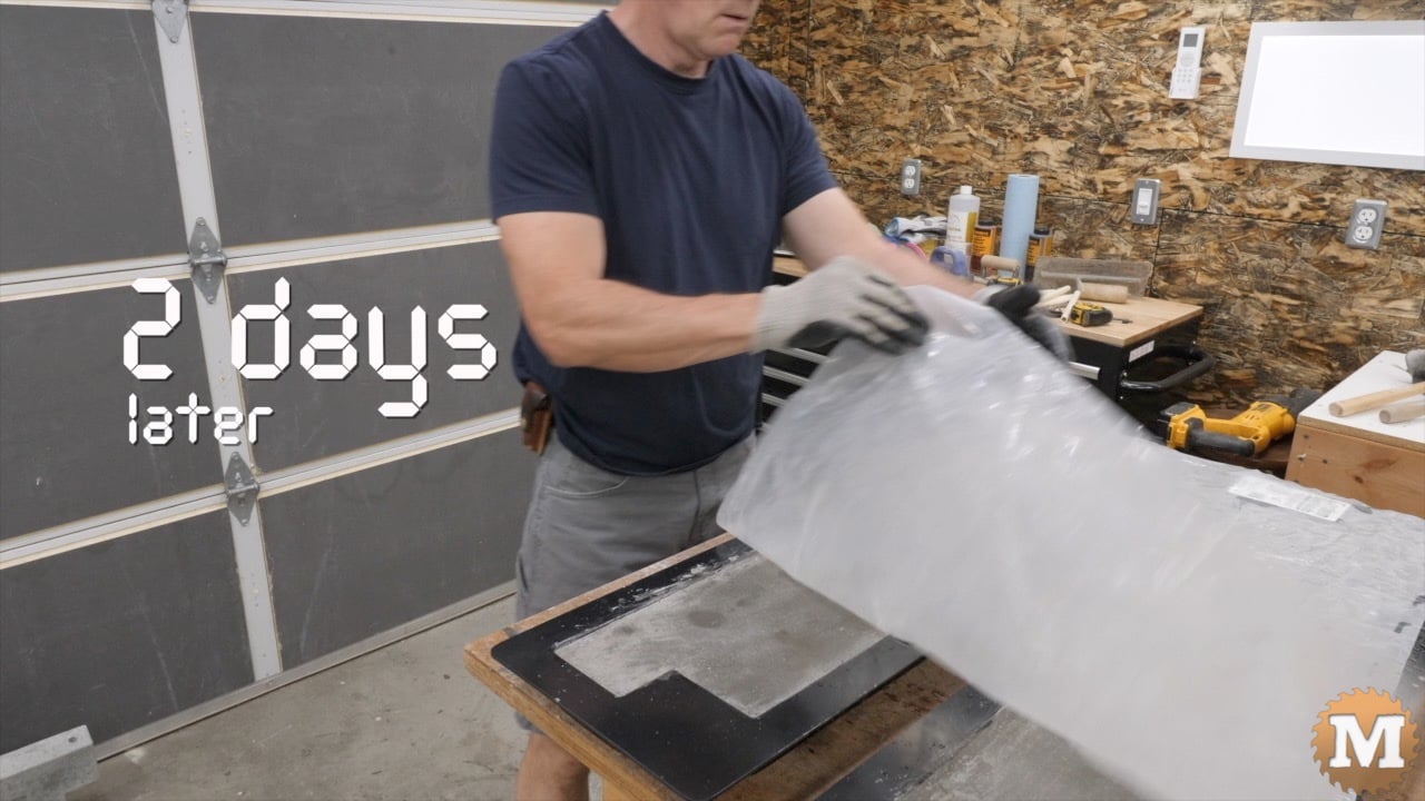 a man uncovering concrete in moldsd