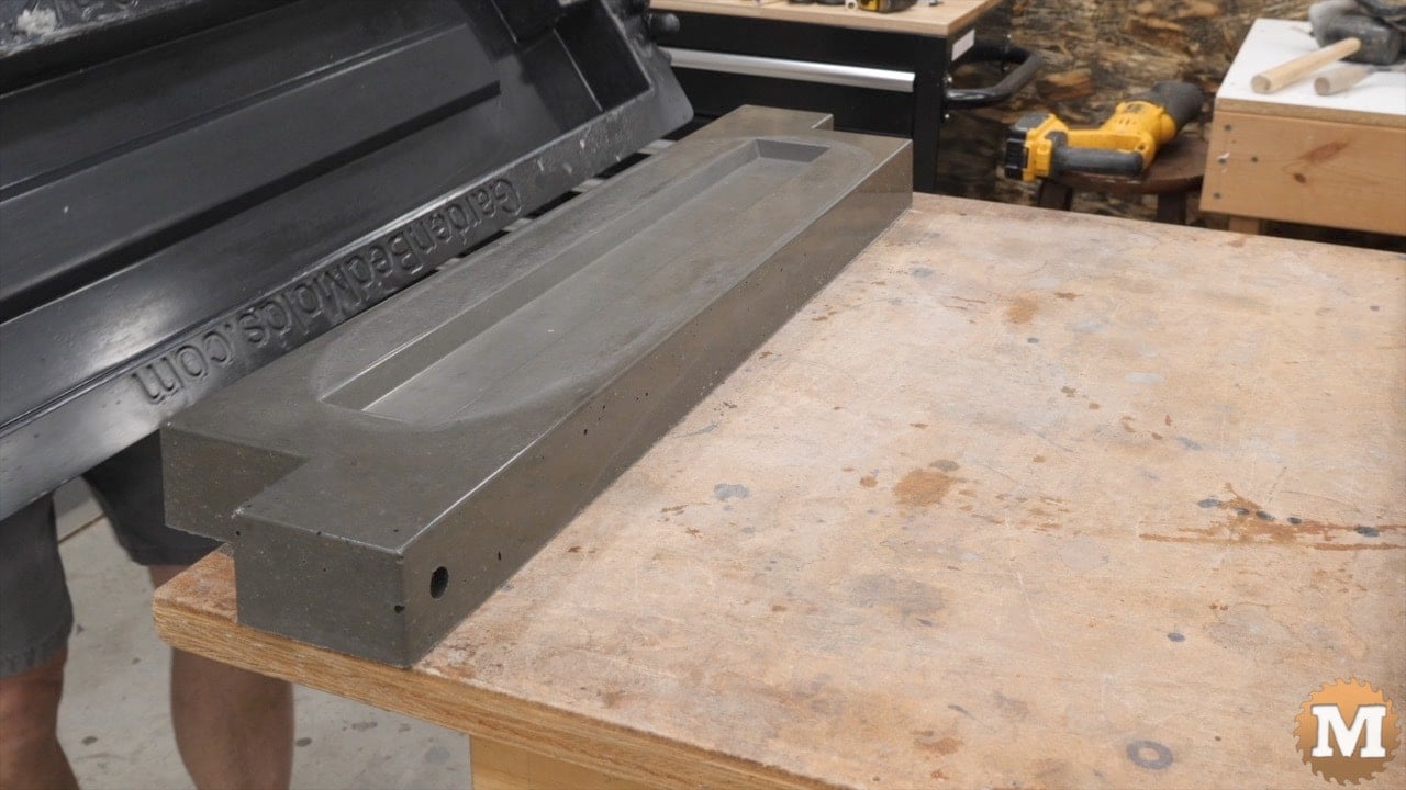 a concrete casting and plastic mold on a workbench