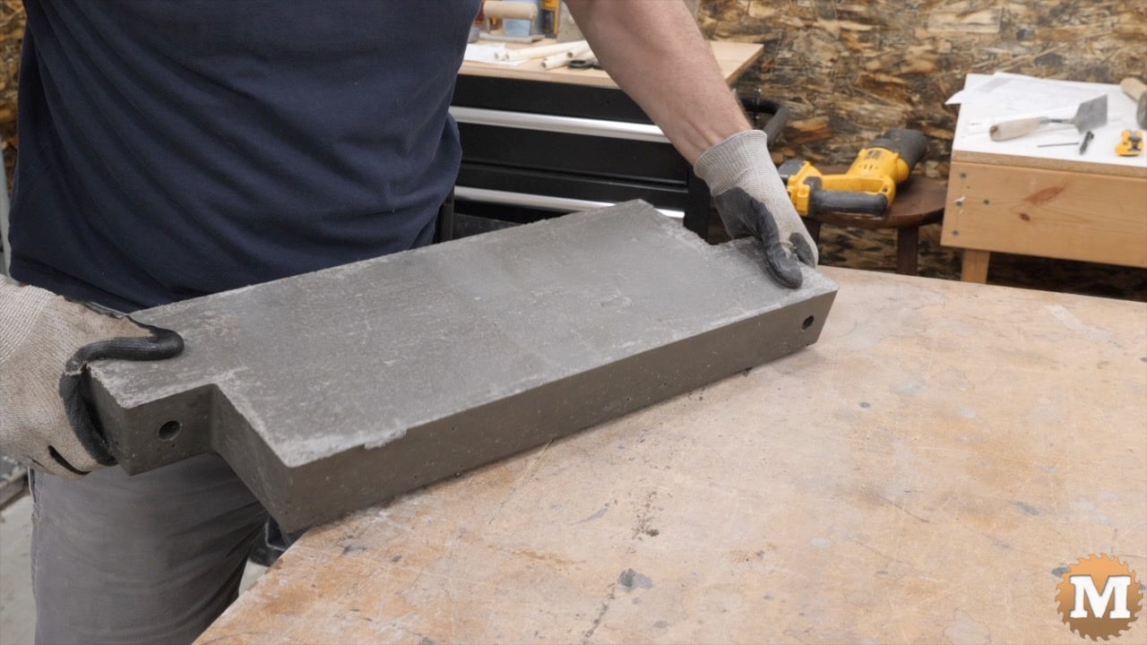 a man holding a concrete casting