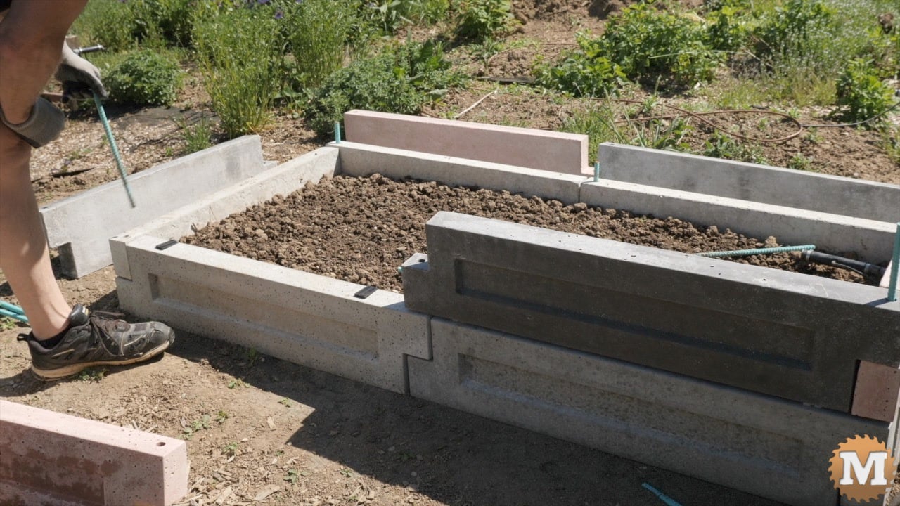 assembling concrete panels into a raised garden bed