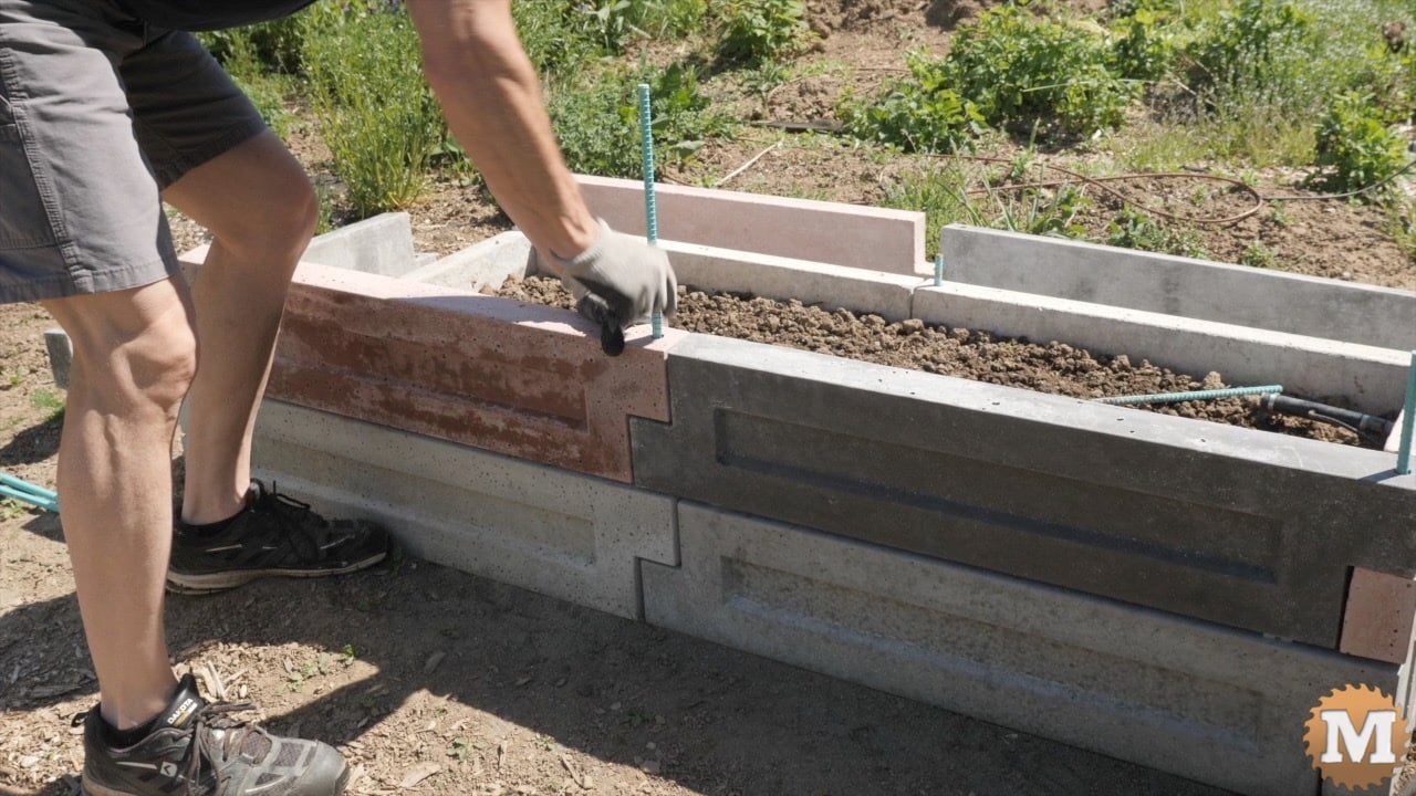 assembling concrete panels into a raised garden bed
